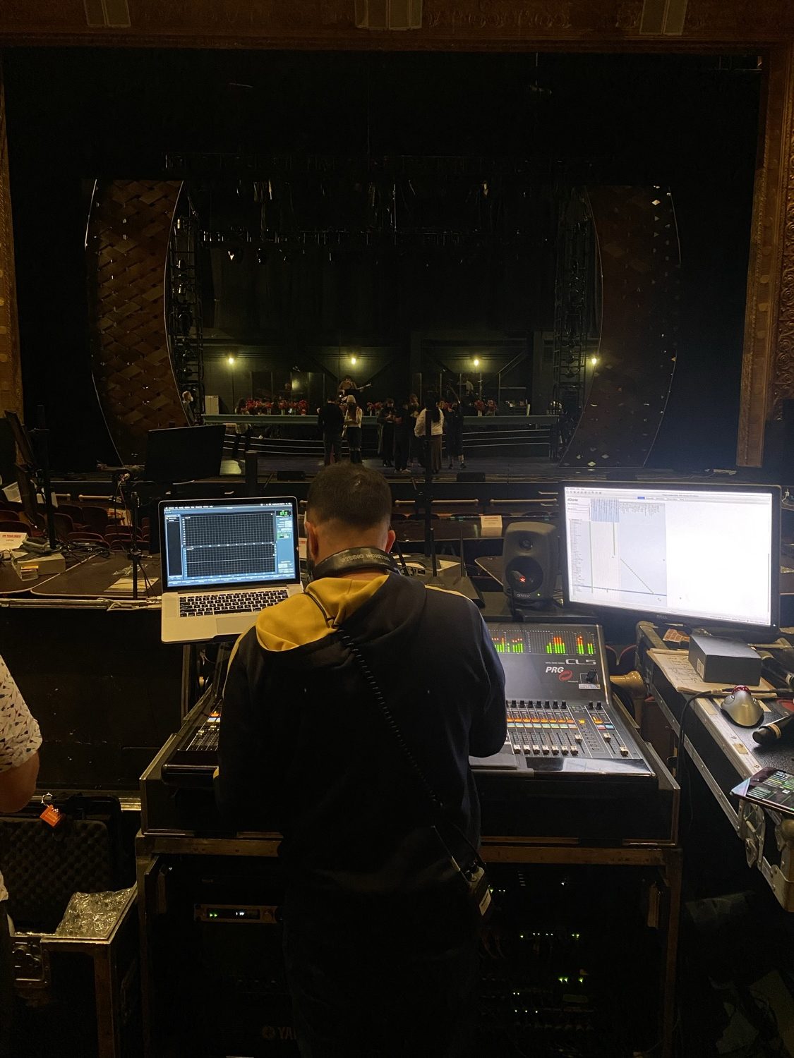 Diego Garzón mixing front-of-house at a theatre console during a rehearsal